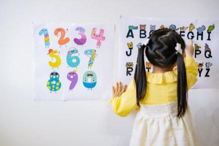 Child Playing with Numbers and Letters