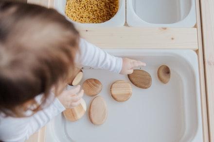 Toddler Playing With Wooden Toys