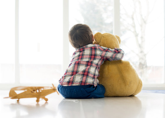 Kid hugging teddy