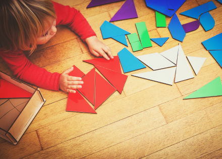 Child arranging colourful paper