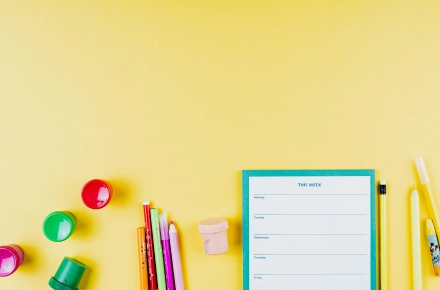 Visual Planner on yellow background, surrounded by colourful stationary